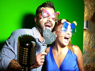 Wedding guests use the Smileme Photobooth video feature with props for their wishes in Corfu